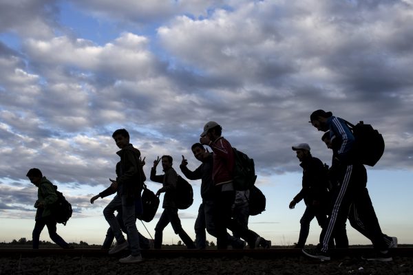 Migrants walk along rail tracks as they arrive to a collection point in the village of Roszke in Hungary after crossing the border from Serbia, September 6, 2015, . Thousands of refugees and migrants streamed into Germany on Sunday, many traveling through Austria from Hungary where they had been stranded against their will for days, while European Union governments argue over how to respond. REUTERS/Marko Djurica